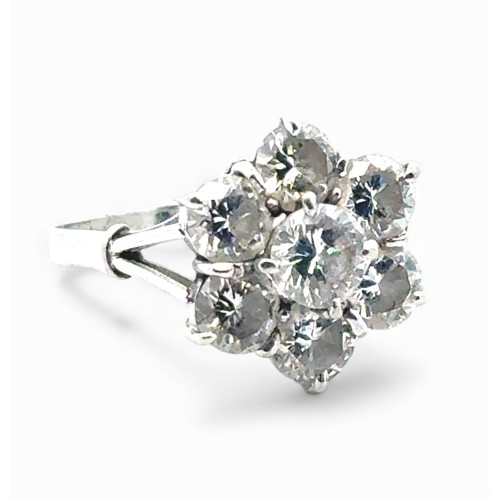 9 - A diamond cluster flower ring in a white metal mount stamped 18ct and platinum. Size P. Total estima... 