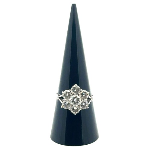 9 - A diamond cluster flower ring in a white metal mount stamped 18ct and platinum. Size P. Total estima... 