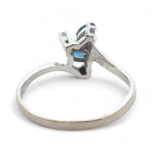 49 - A London topaz set ring with diamond accents stamped 585, size L/M. Diamond weight 0.03ct.