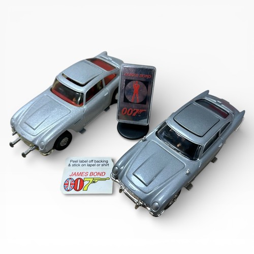 47 - Corgi Aston Martin DB5 silver pair, both with 2 figures and unboxed, with mirrored display stand and... 