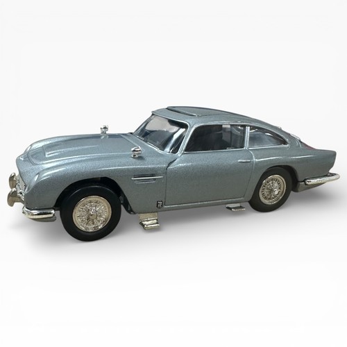 47 - Corgi Aston Martin DB5 silver pair, both with 2 figures and unboxed, with mirrored display stand and... 
