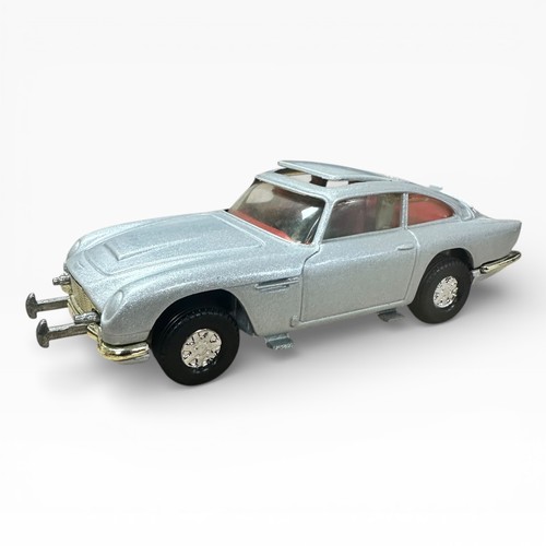 47 - Corgi Aston Martin DB5 silver pair, both with 2 figures and unboxed, with mirrored display stand and... 