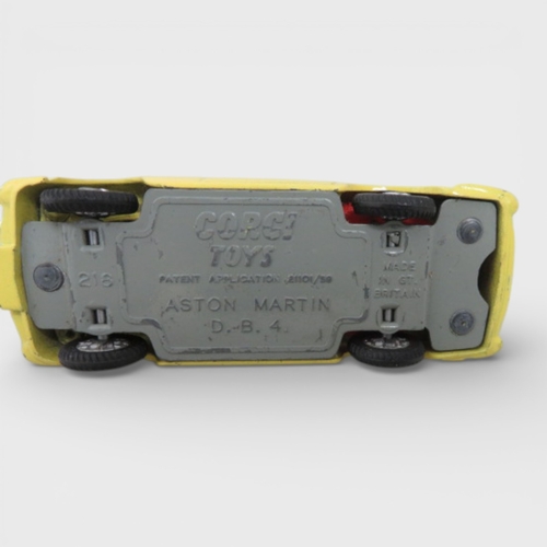 31 - Corgi No. 218 Aston Martin DB4, yellow with red interior and spoked hubs, generally excellent to goo... 