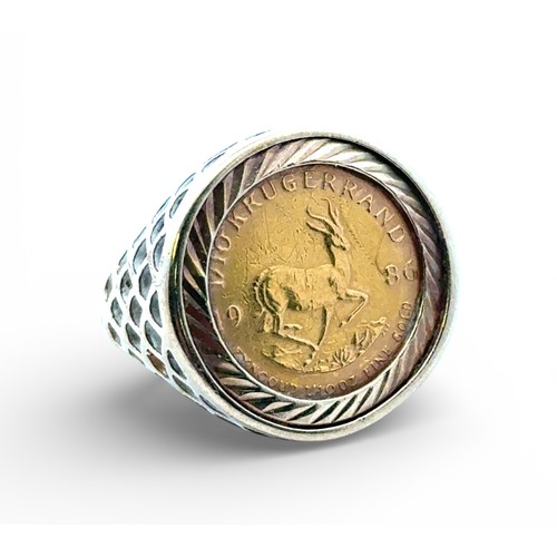 5 - A 1/10 Krugerand (1986) signet ring set in a 9ct yellow gold mount with pierced shoulders. Size M wi... 