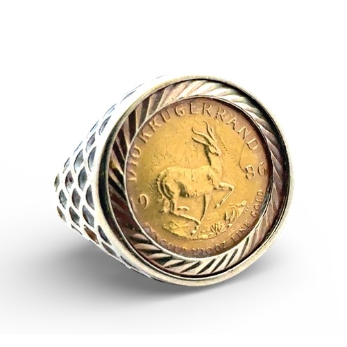 5 - A 1/10 Krugerand (1986) signet ring set in a 9ct yellow gold mount with pierced shoulders. Size M wi... 