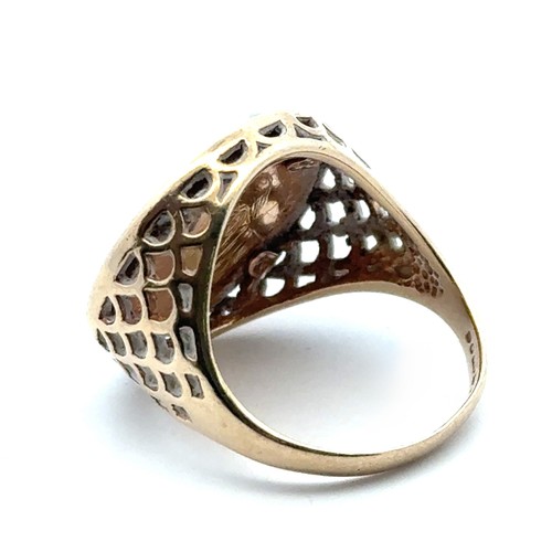 5 - A 1/10 Krugerand (1986) signet ring set in a 9ct yellow gold mount with pierced shoulders. Size M wi... 