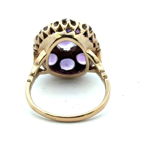 75 - A 9ct gold and amethyst cluster dress ring, size Q. Some stones with large chips. 7.29g