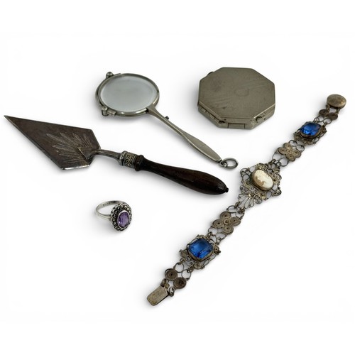 112 - An amethyst and marcasite dress ring size N, a blue paste and white metal bracelet, white metal comp... 