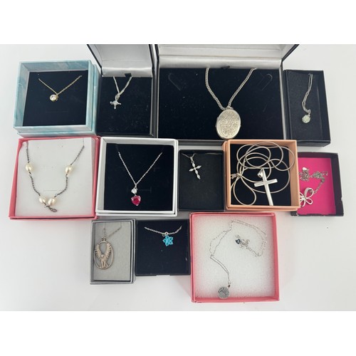 100 - 12 Silver / 925 necklaces, to include a silver locket, a silver cross necklace, and others set with ... 