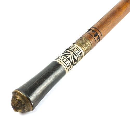 217 - An early 20th century Indian swordstick, horn and carved bone handle, with a brass Lion mask cap, wo... 