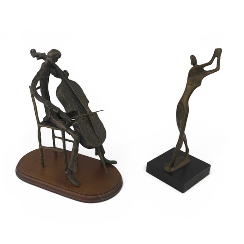 645 - Two bronze figures. A figure playing the cello, 26cm high, with a wooden base.  And a figure with ra... 