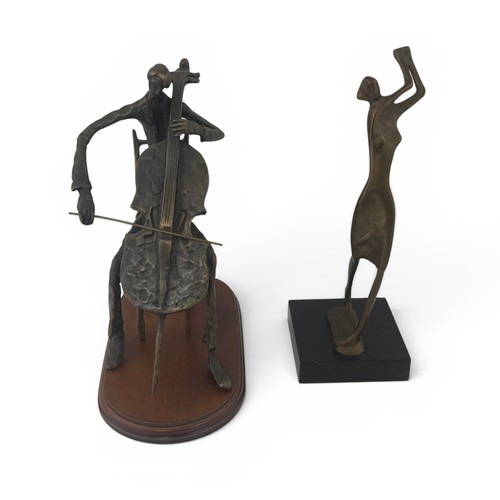 645 - Two bronze figures. A figure playing the cello, 26cm high, with a wooden base.  And a figure with ra... 