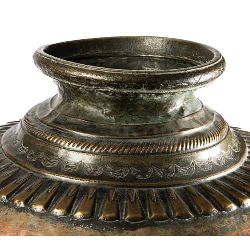705 - A large South Indian copper water pot / planter. Foliate surround to upper with hammered patina. Hei... 