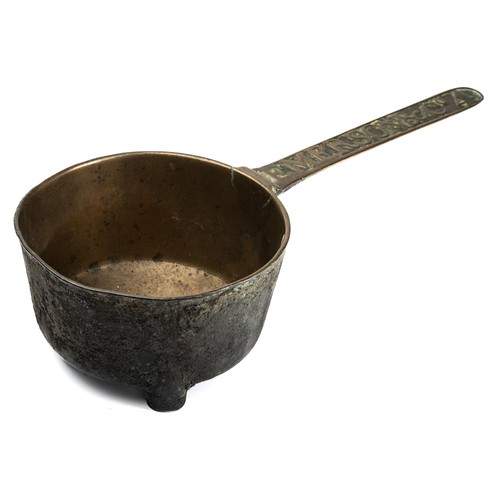 671 - An 18th century cast bronze skillet or posnet, rasied on lug feet, the long handle cast with the fou... 