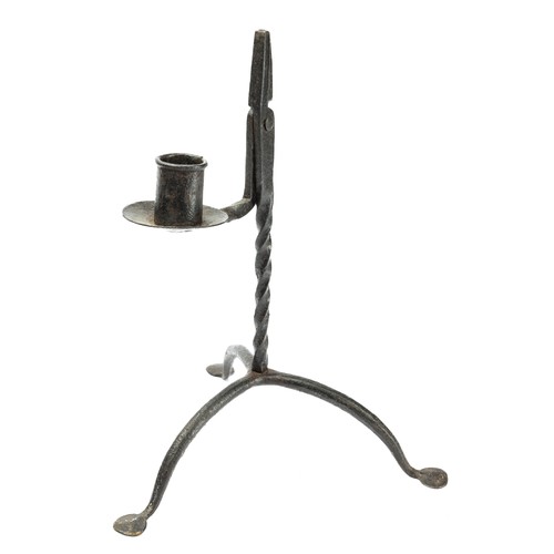 710 - A wrought iron rushlight and candle holder, of 17th century design, barley twist stem raised on trif... 