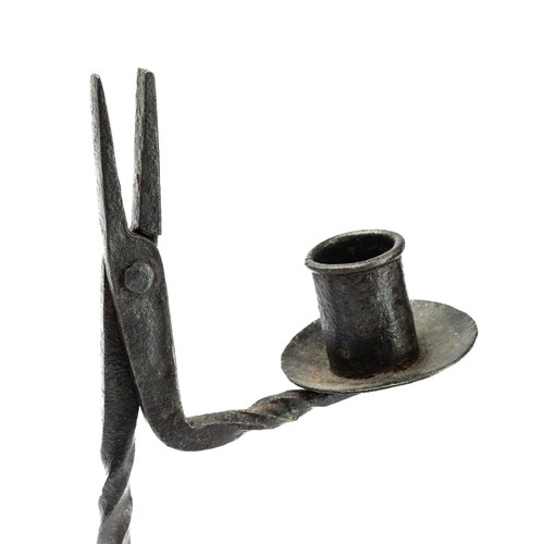 710 - A wrought iron rushlight and candle holder, of 17th century design, barley twist stem raised on trif... 