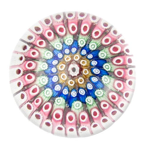 640 - A millefiori glass paperweight, having concentric rings of coloured canes, raised on a ring turned b... 