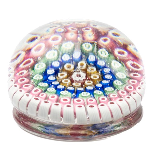 640 - A millefiori glass paperweight, having concentric rings of coloured canes, raised on a ring turned b... 
