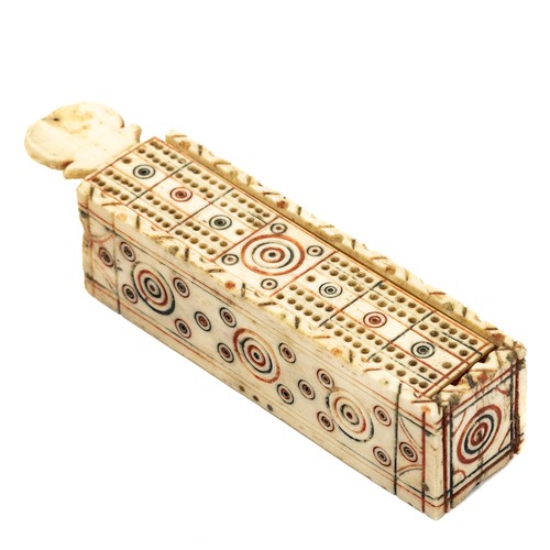 654 - An early 19th century, Napoleonic prisoner of war, bone  domino box, carved circle decoration, red a... 