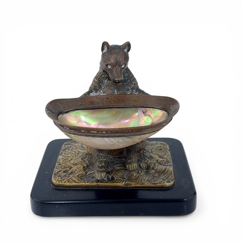 650 - An early 20th Century bronze table salt in the form of a Black Forest bear. The bear seated on a log... 