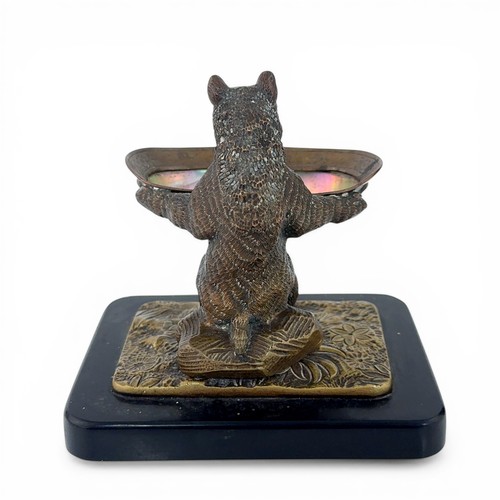 650 - An early 20th Century bronze table salt in the form of a Black Forest bear. The bear seated on a log... 