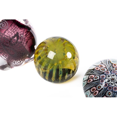 642 - A collection of nine glass paperweights, includes a Caaithness titled 