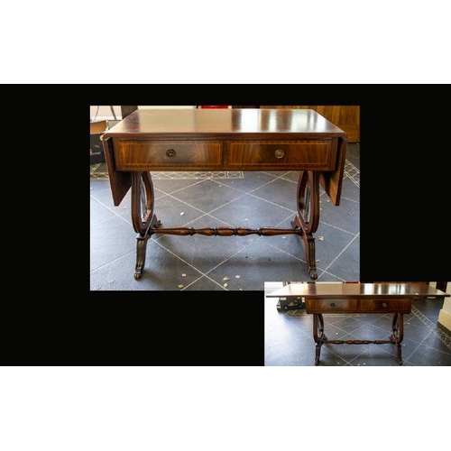 1047 - A Mahogany Sofa Table Of typical form with lyre shaped supports, turned cross stretcher, terminating... 