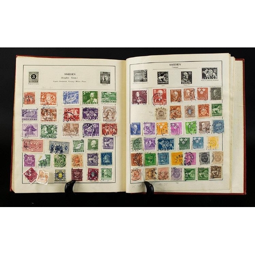 1438 - Red Strand Stamp Album full of stamps from around the world. Very few hinge remains so lightly picke... 