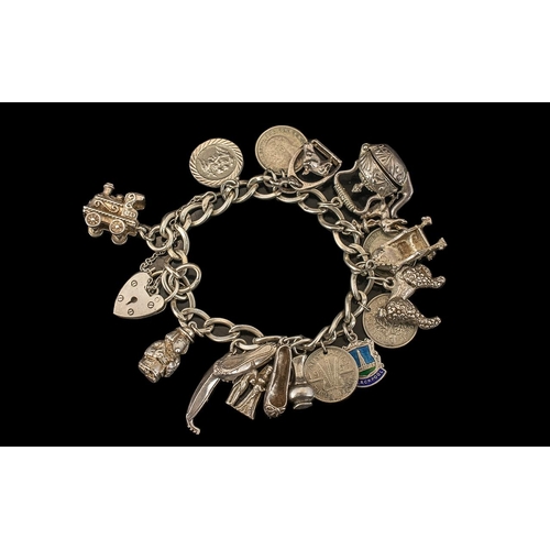 293 - Solid Silver Charm Bracelet, loaded with charms, comprising: ballet shoes, jug, sixpence,poodle, thr... 