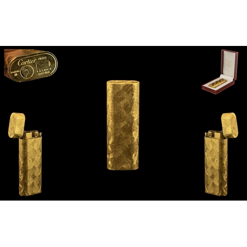 35 - A Cartier Paris Cigarette Lighter of typical gold textured form. Marked to base Cartier Paris plaque... 