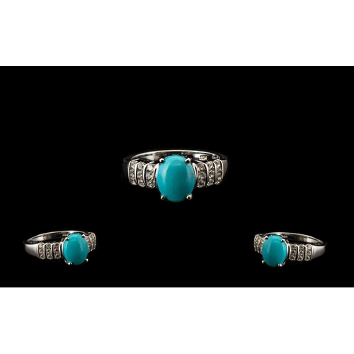 361 - Sleeping Beauty Turquoise and White Zircon Ring, an oval cut cabochon of over 2cts of the bright, ma... 