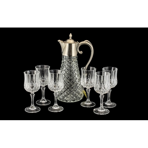 796 - Drinker's Interest - A Large Cut Glass Lidded Wine Jug with plated lid and handle, along with six cr... 