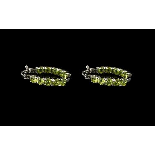 311 - Peridot Small Hoop Earrings, oval cut peridots set vertically to the front and the inside back of th... 