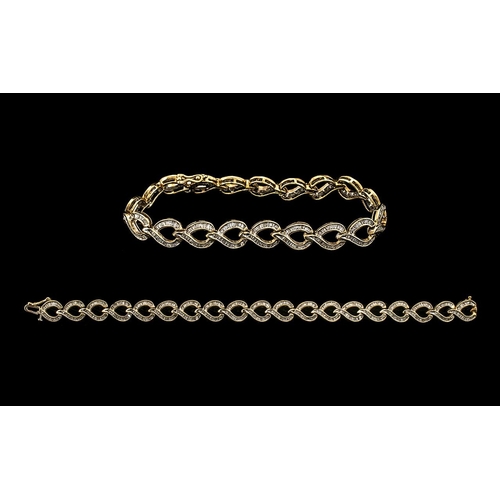 26 - Ladies - Attractive 10ct Gold Baguette Diamond Set Tennis Bracelet of Contemporary Design. Marked 10... 