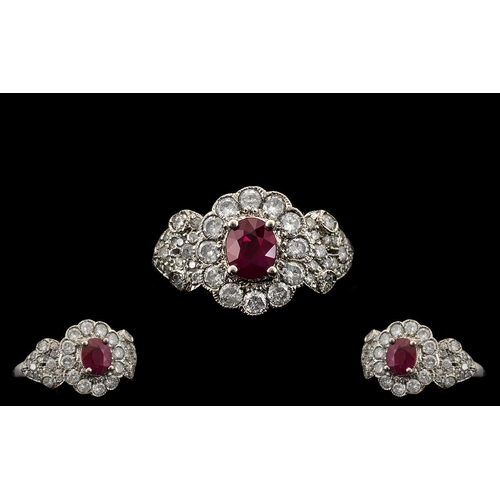 60 - Ladies Attractive 18ct White Gold Ruby and Diamond Set Stylish Cluster Ring, the central ruby surrou... 