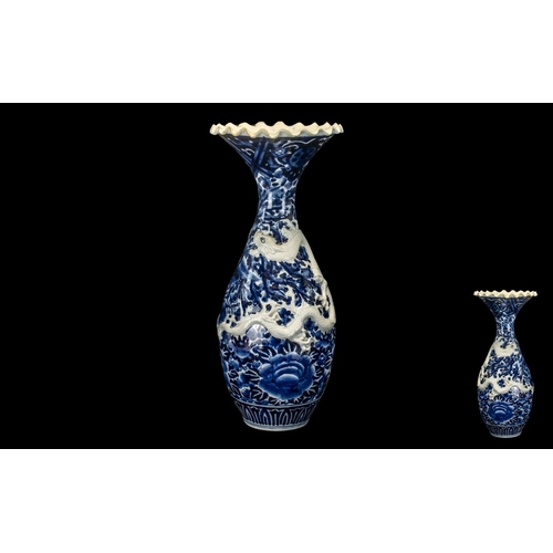 807 - Large Japanese Meiji Period Embossed Dragon Vase with floral decoration in underglaze blue and an ap... 