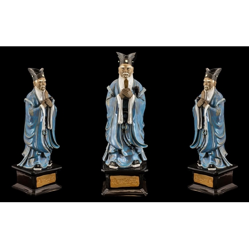 808 - Chinese Glazed Pottery Figure of a Deity holding a symbol, wearing blue robes; standing on a square ... 