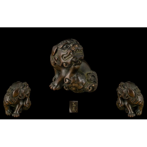 838 - An Oriental Boxwood Netsuke in the form of a foo dog, well carved. Signed to underside. Please see a... 