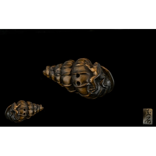 839 - An Oriental Boxwood Netsuke in the form of frogs playing on a shell. Signed to underside. Please see... 