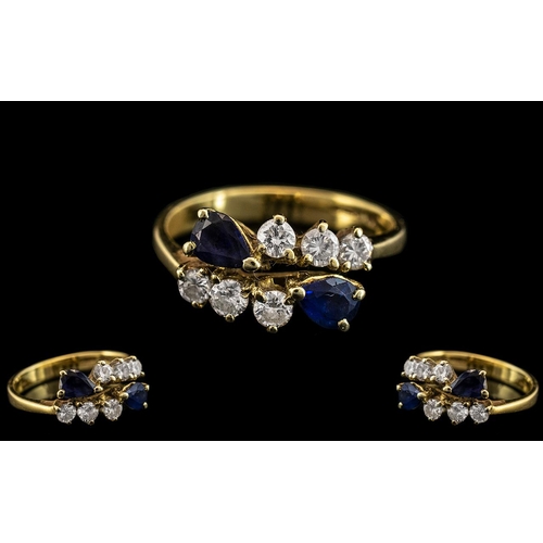 84 - 18ct Gold - Good Quality Sapphire and Diamond Set Dress Ring. Marked 750 - 18ct. The Round Brilliant... 