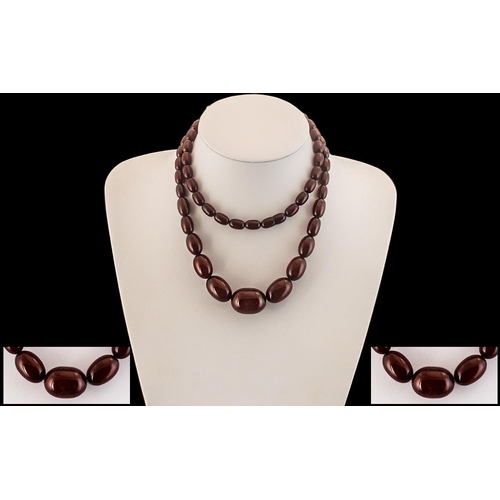 64 - Early 20th Century Long Graduated Cherry Coloured Bakelite Beaded Necklace of Good Colour. Please Co... 