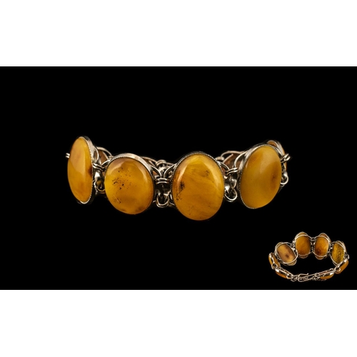 165 - Butterscotch Amber/Bakelite Bracelet.  Amber bracelet in white metal.  Largest stone being 11''.  At... 