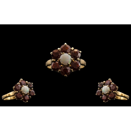 65 - Ladies 9ct Gold Garnet and Opal Set Cluster Ring - Flower head Setting. The Central Opal Surrounded ... 