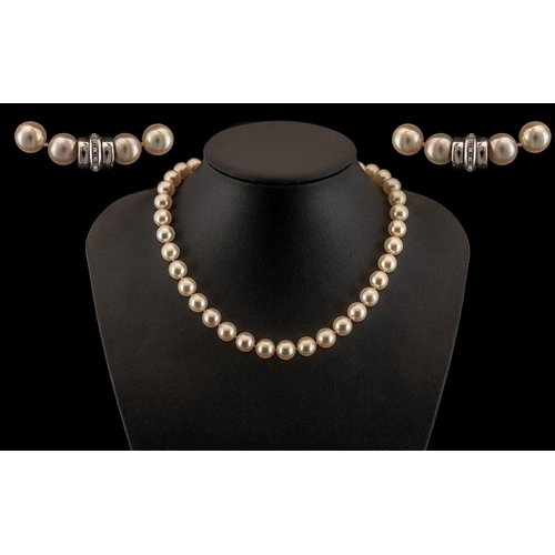 93 - A Superb Quality Single Strand Cultured Pearl Necklace with 14ct White Gold Diamond Set Clasp. Marke... 