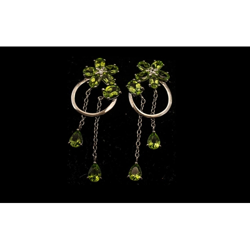 198 - Peridot Cluster and Long Drop Earrings, 8cts of the sparkling green peridot, in oval cuts to the flo... 