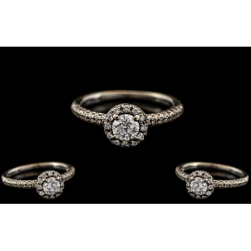 57 - 18ct White Gold - Superb and Attractive Diamond Set Dress Ring. The Central Modern Round Brilliant C... 