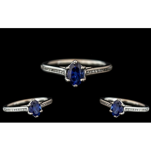 71 - Platinum - Contemporary Sapphire and Diamond Set Dress Ring. The Faceted Cornflower Blue Sapphire of... 