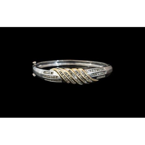 49 - 14ct White Gold Diamond Hinged Bangle, The Front Set With Channel Set Round Brilliant And Tapering B... 