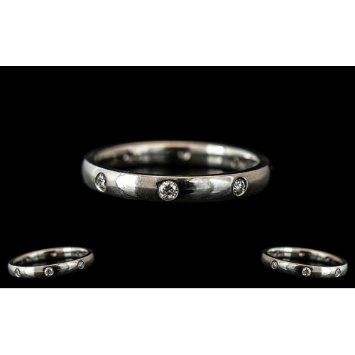 125A - A Platinum Diamond Set Wedding/Eternity Ring,  set with eight round brilliant cut diamonds, fully ha... 