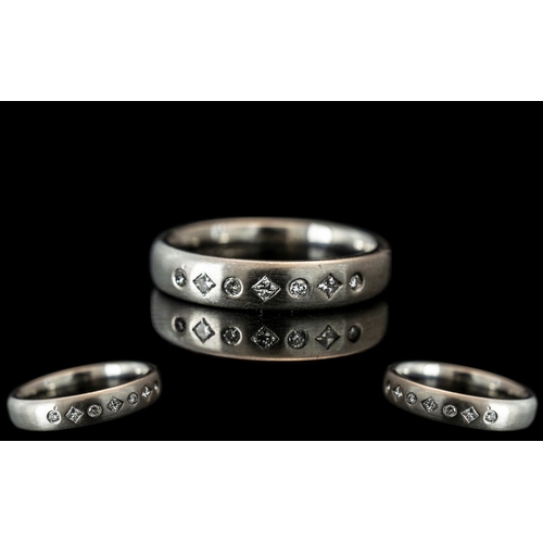 130A - A Platinum Diamond Set Wedding/Eternity Ring,  set with  seven alternating round brilliant cut and p... 